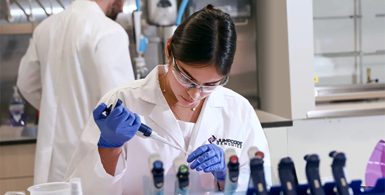 Technician injecting fluid into a testube